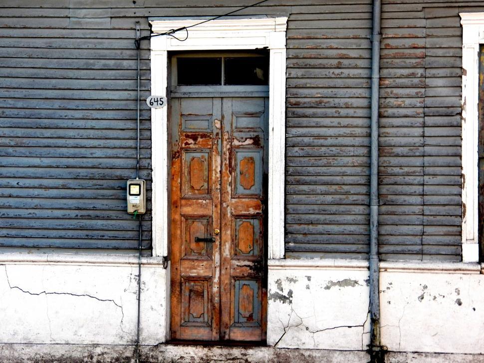 Free Image of Old Wooden Door in Front of Gray Building 
