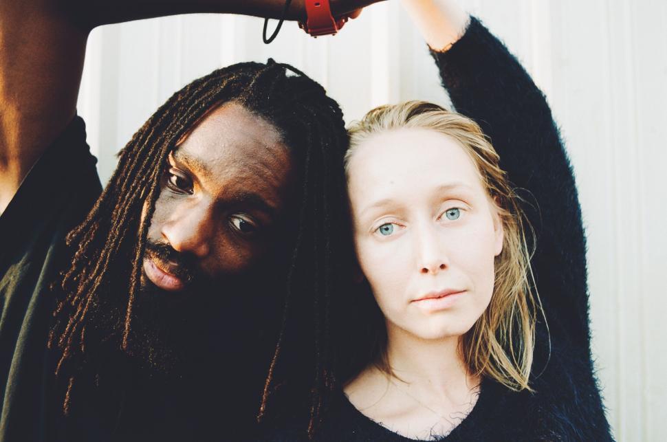 Free Image of Woman Standing Next to Man With Dreadlocks 