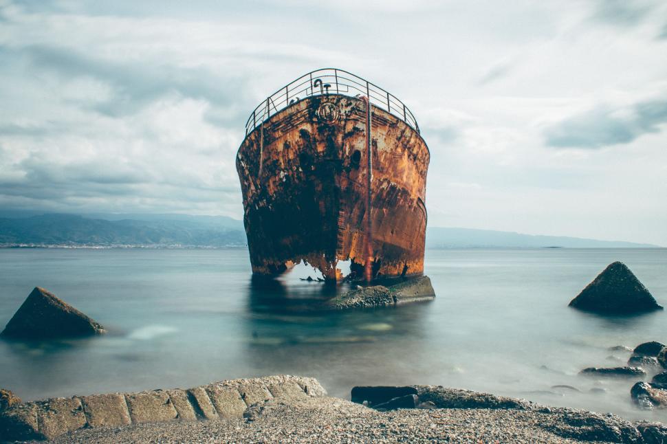 Free Image of Rusted Boat Abandoned on Water 