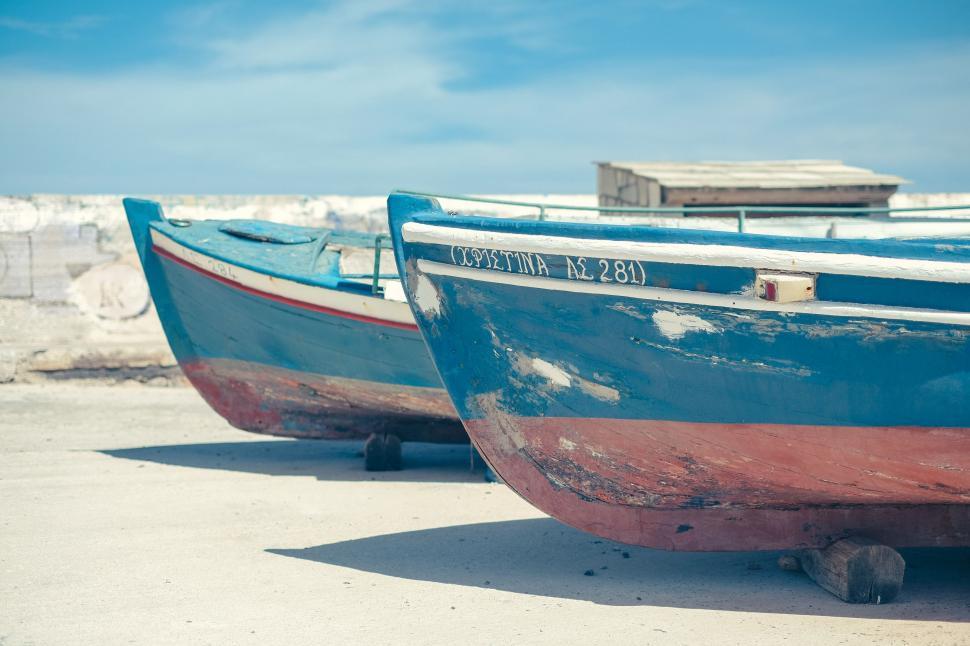 Free Image of Two Boats Resting on Sandy Beach 