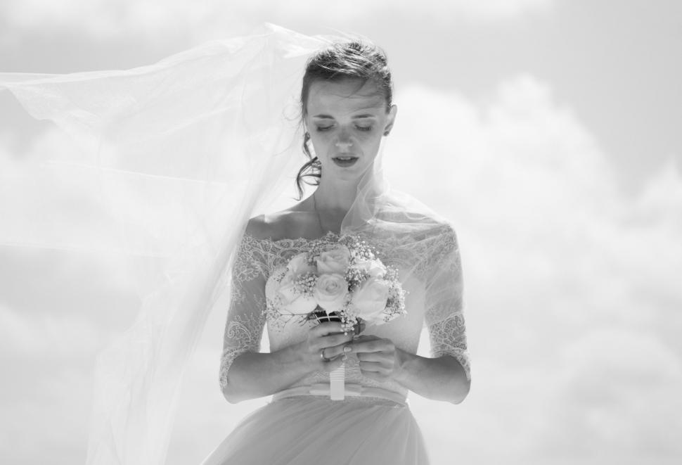 Free Image of Woman in Wedding Dress Holding Bouquet 