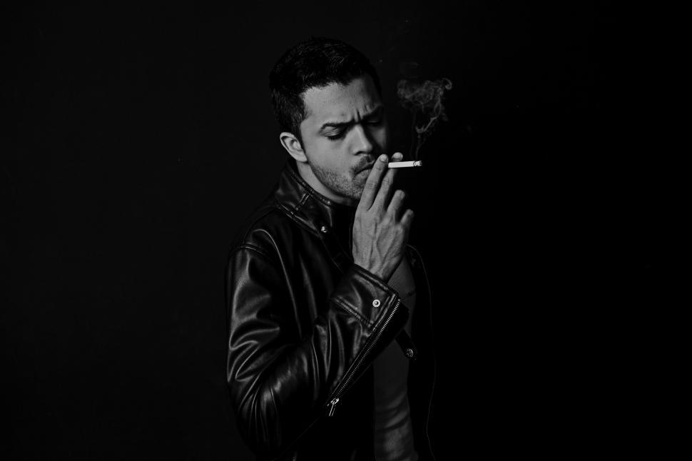 Free Image of Man Smoking Cigarette in the Dark 