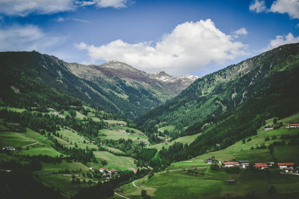 Free Image of Green Valley With Mountains in Background 