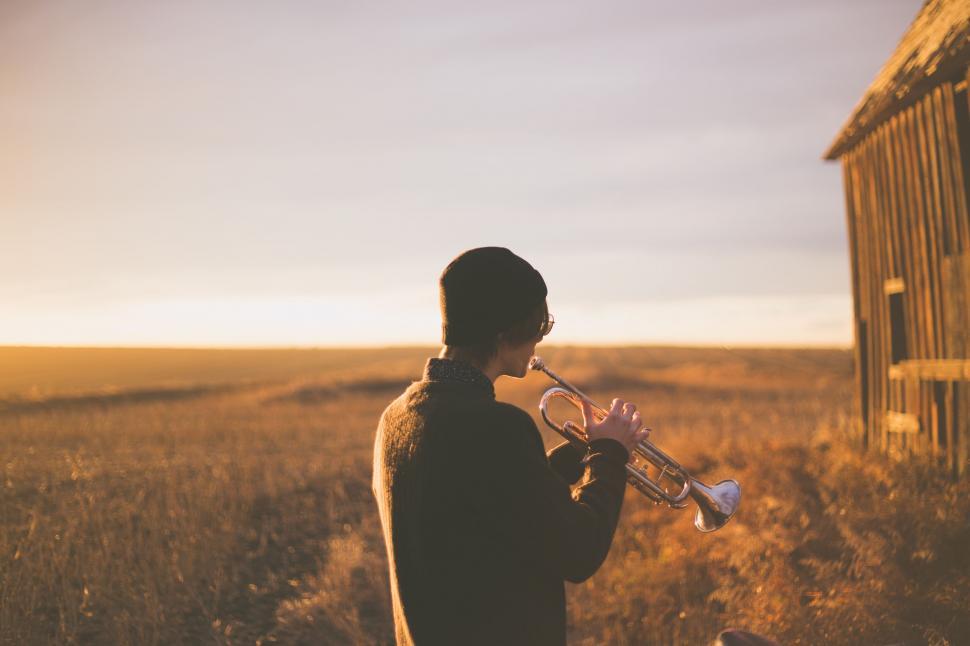 Free Image of Person Standing in Field With Trumpet 