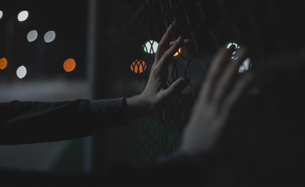 Free Image of Two Hands Reaching for Something in the Dark 