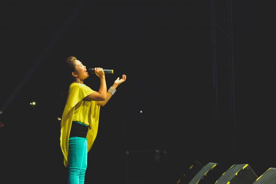Free Image of Person Standing on Stage With Microphone 