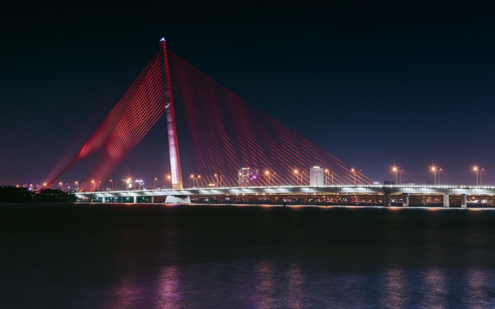 Free Image of Large Bridge Over Body of Water at Night 