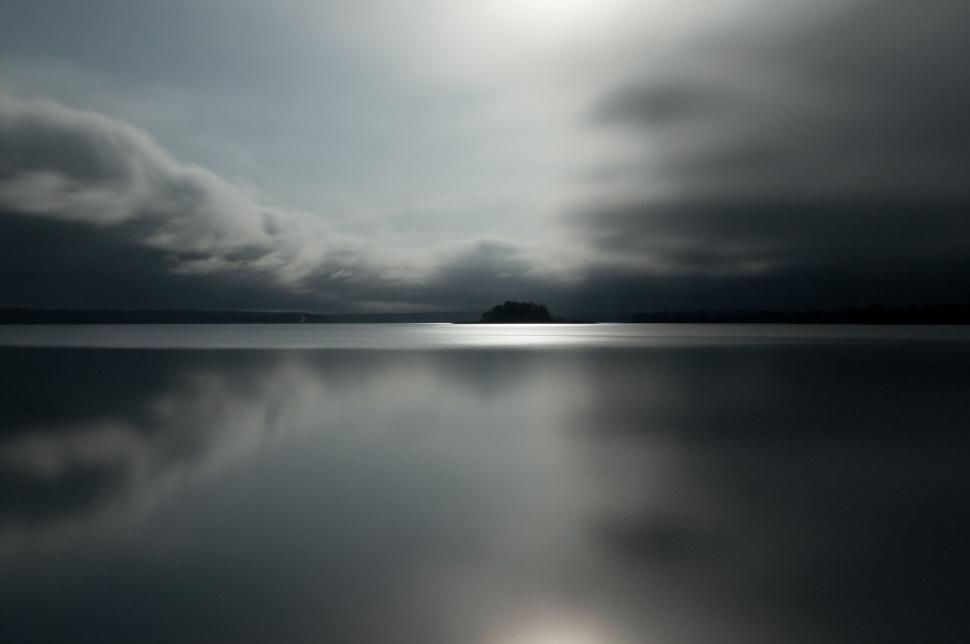 Free Image of Cloudy Sky Over Large Body of Water 
