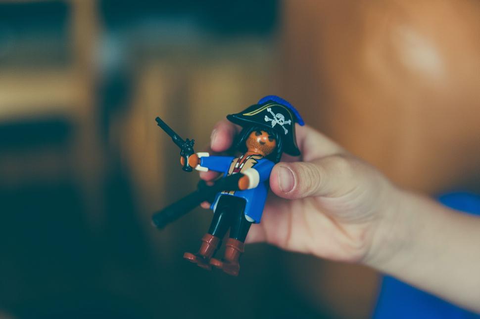 Free Image of Hand Holding Toy With Pirate 
