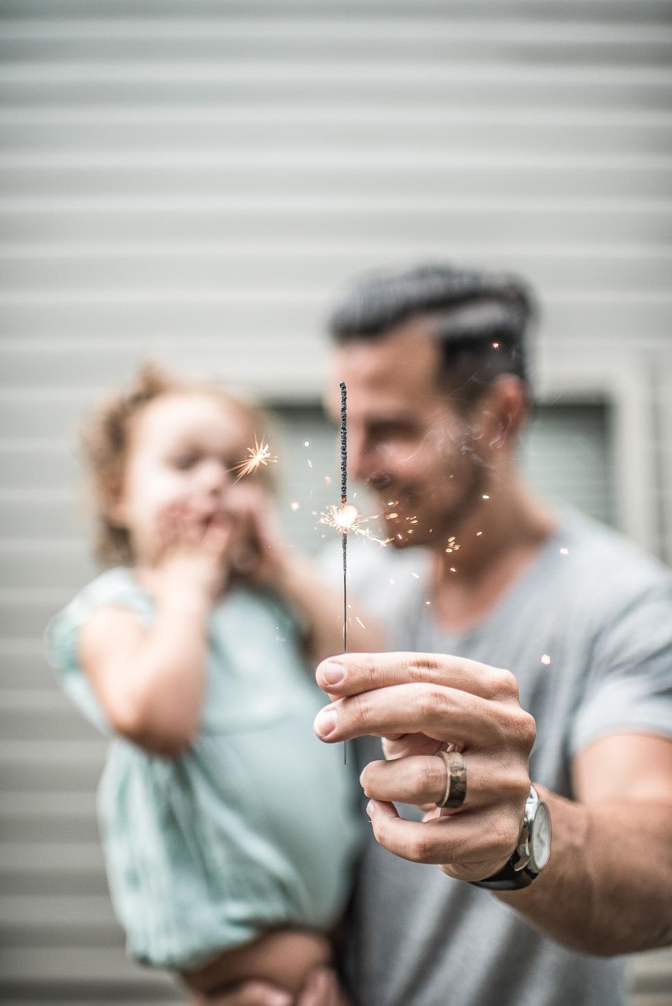 Free Image of Man and Woman Holding Sparkler 