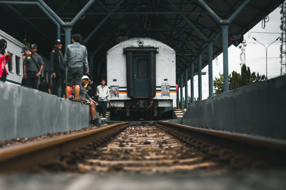 Free Image of Group of People Standing Next to a Train 