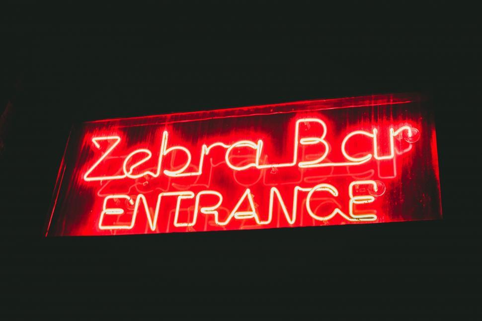 Free Image of Red Neon Sign Saying Zebra Bar Entrance 