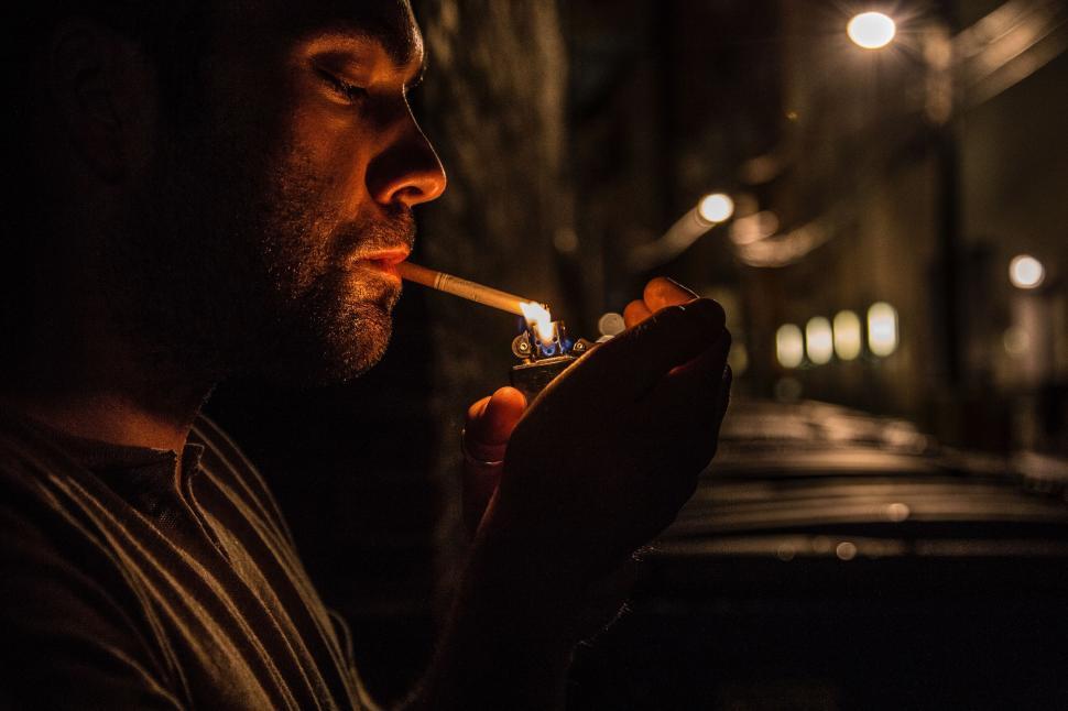 Free Image of Man Smoking a Cigarette in the Dark 