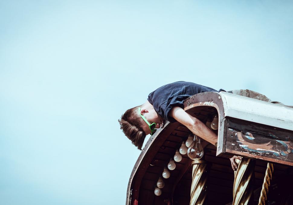 Free Image of Man Laying on Top of Wooden Structure 