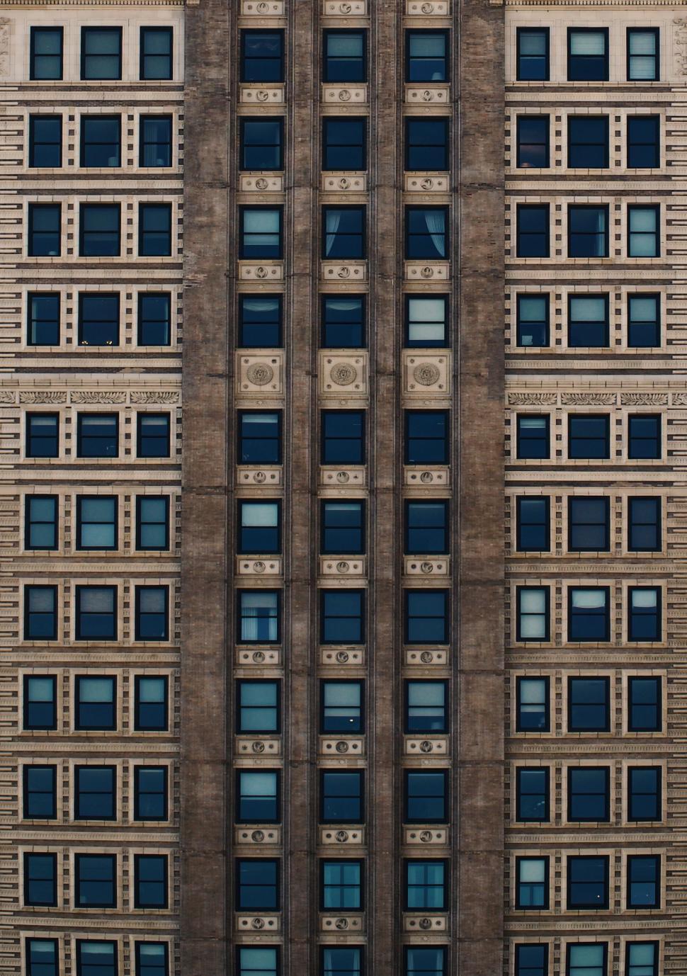 Free Image of building architecture city urban construction apartment window exterior housing modern windows buildings skyscraper sky glass office structure tower house facade downtown business tall high wall building complex home street 