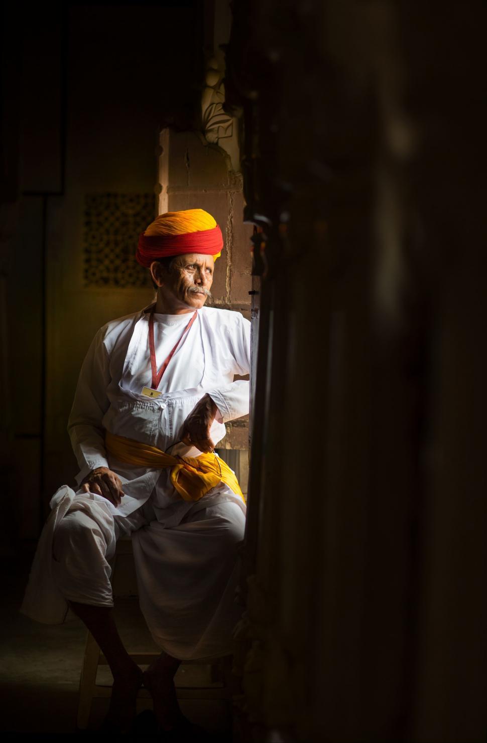 Free Image of A Man in a Turban Sitting on a Chair 