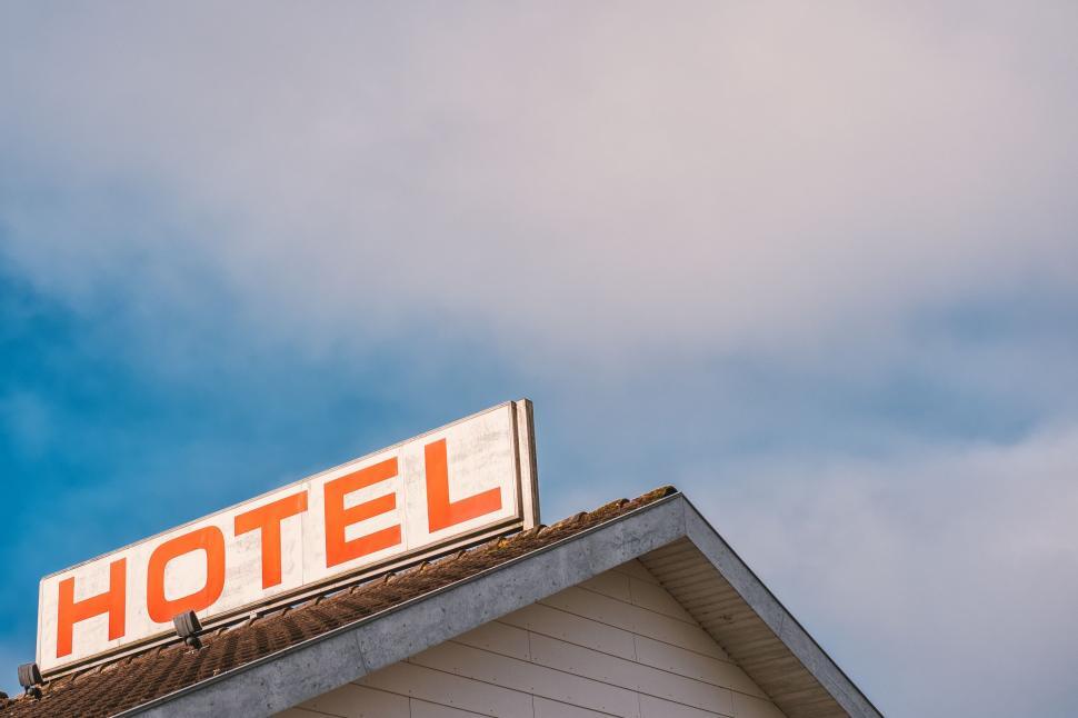 Free Image of Hotel Sign Atop Building 