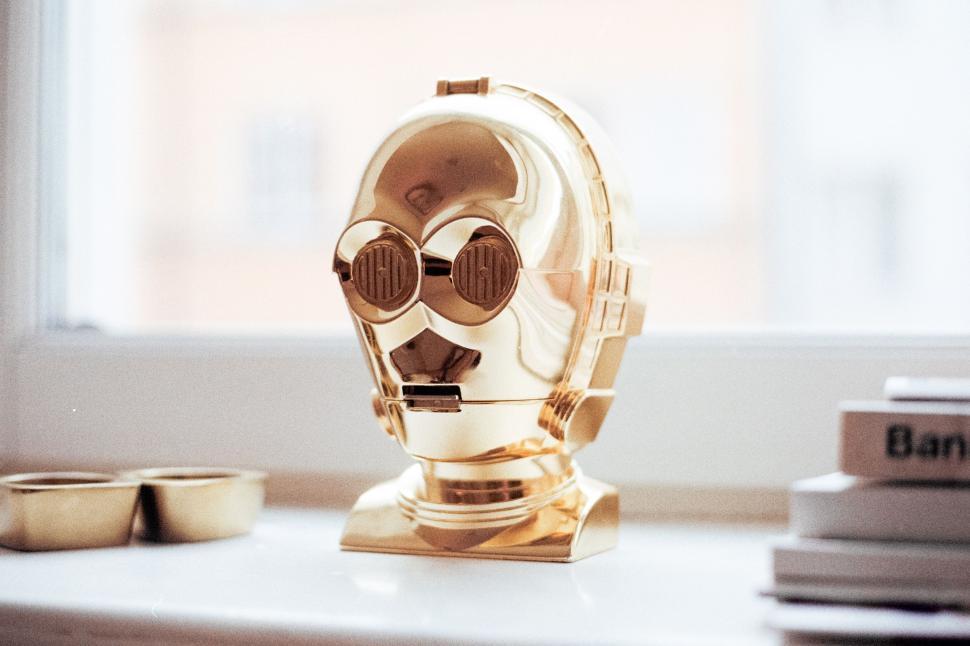 Free Image of Gold Robot Statue Sitting on Table 