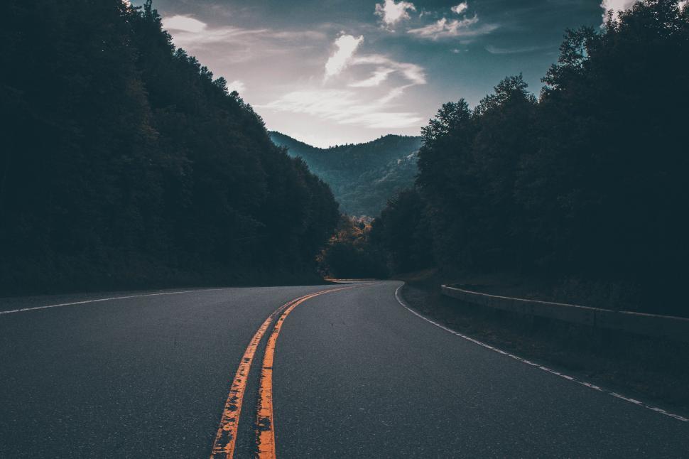 Free Image of Empty Road With Mountain in the Background 
