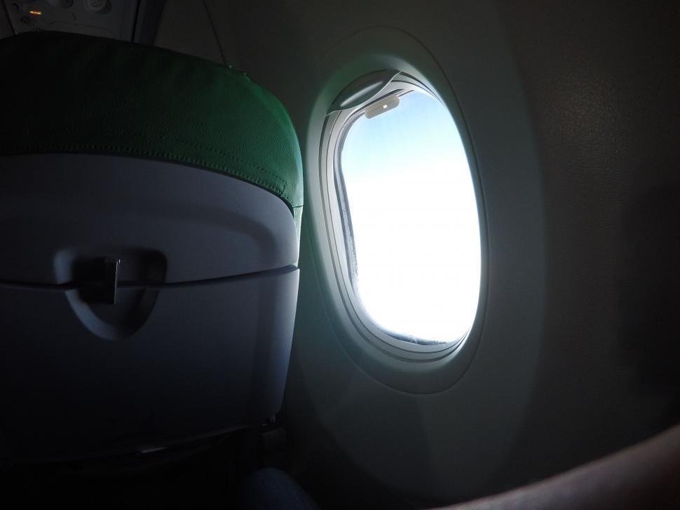 Free Image of Light Shining Through Airplane Window 