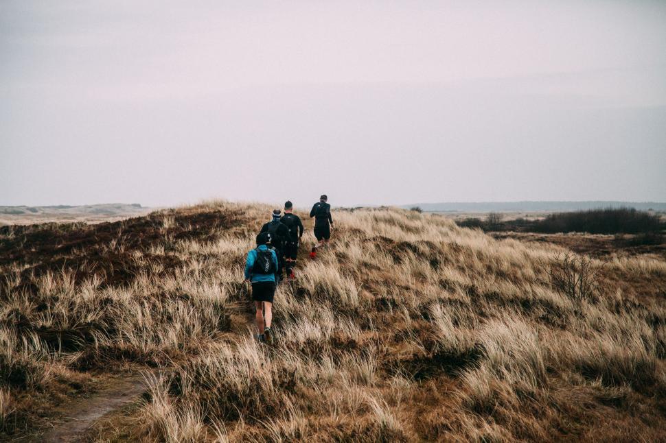 Free Image of Group of People Hiking Up a Hill 