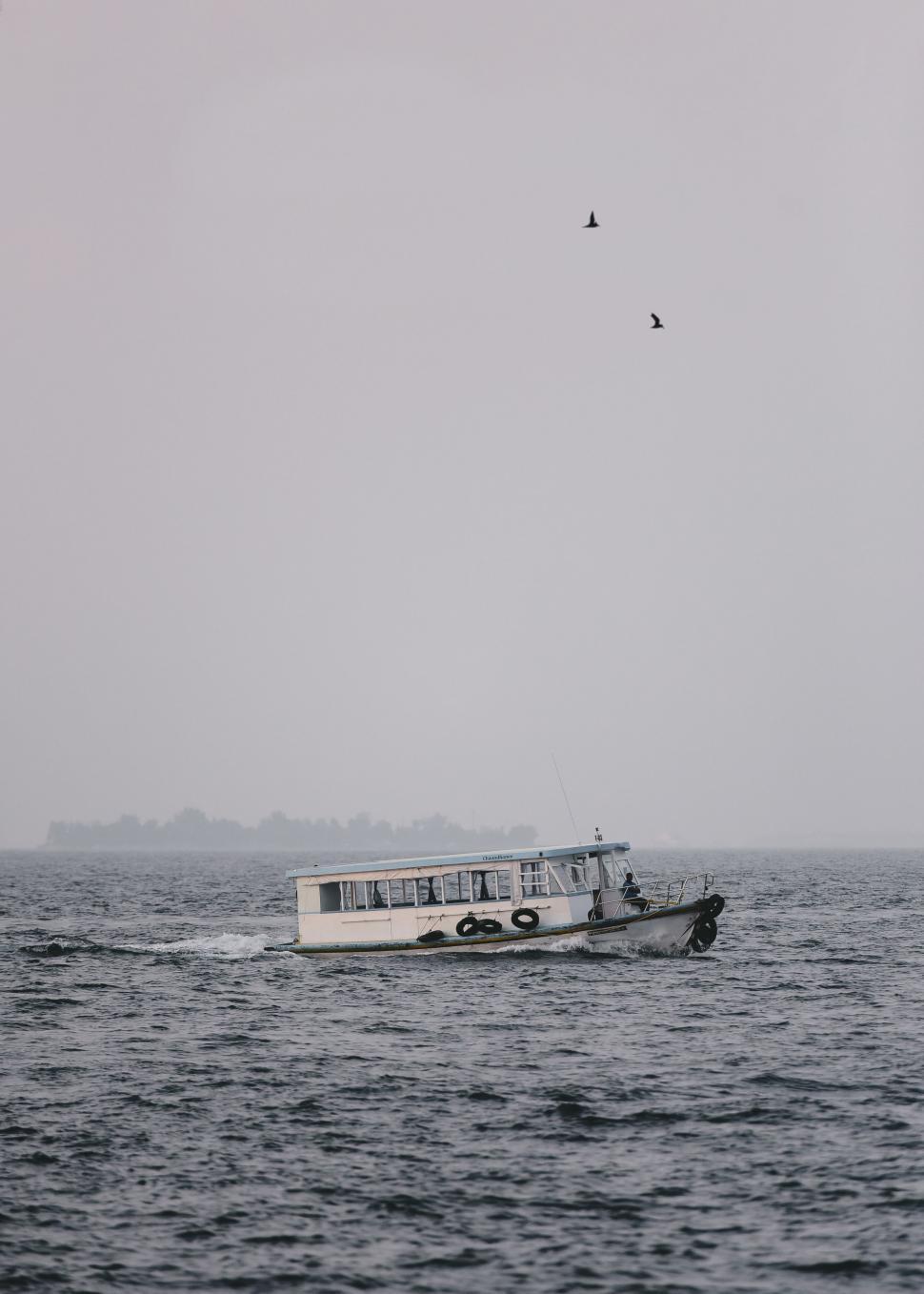 Free Image of Small Boat Adrift in Vast Ocean 