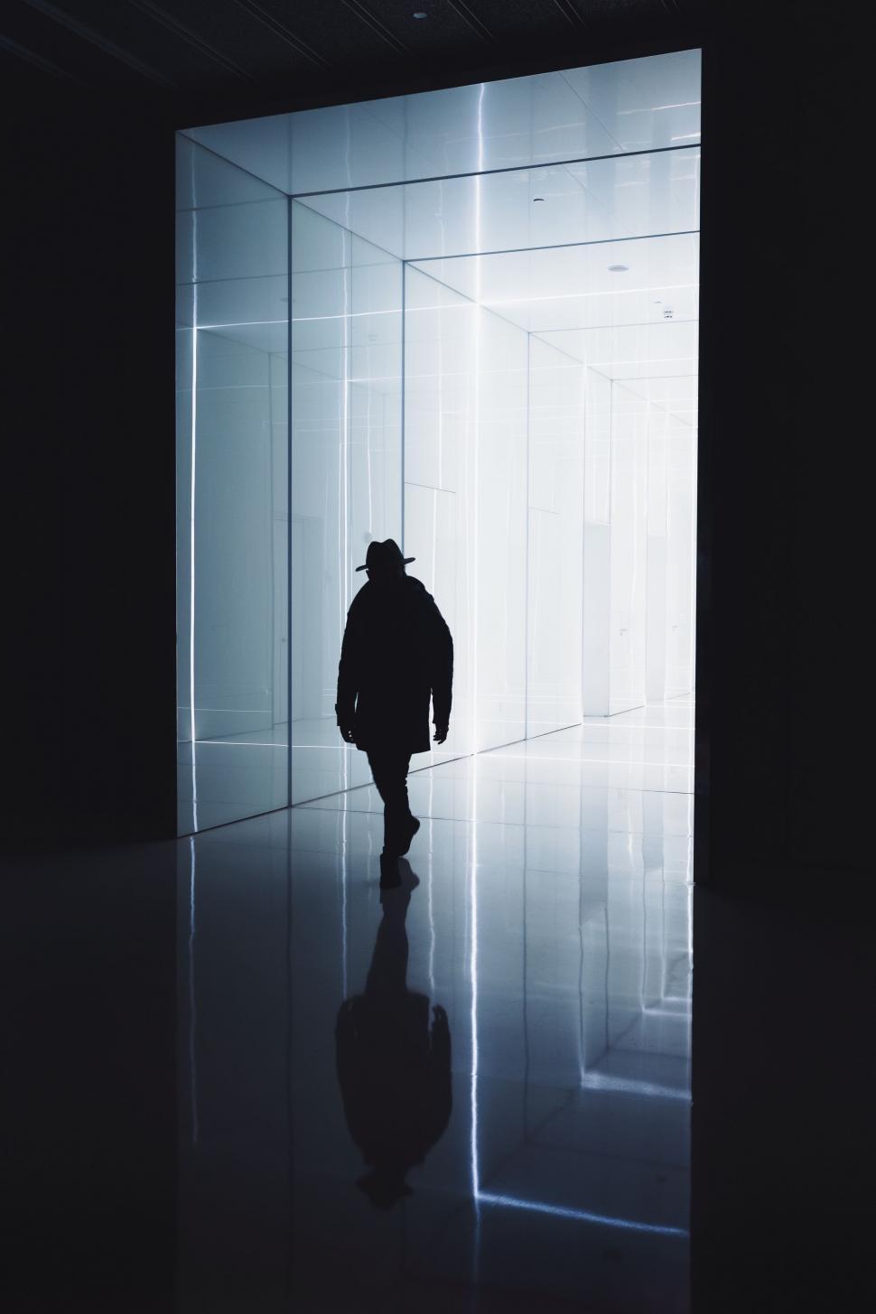Free Image of Man Walking Through Dark Room 