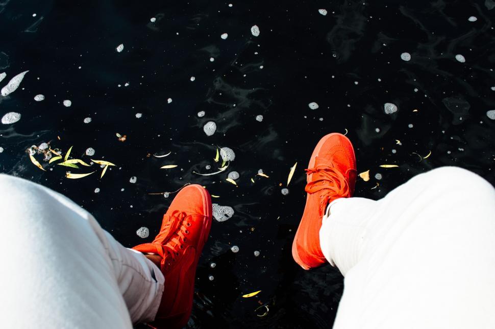 Free Image of Feet in Orange Shoes Standing in Snow 