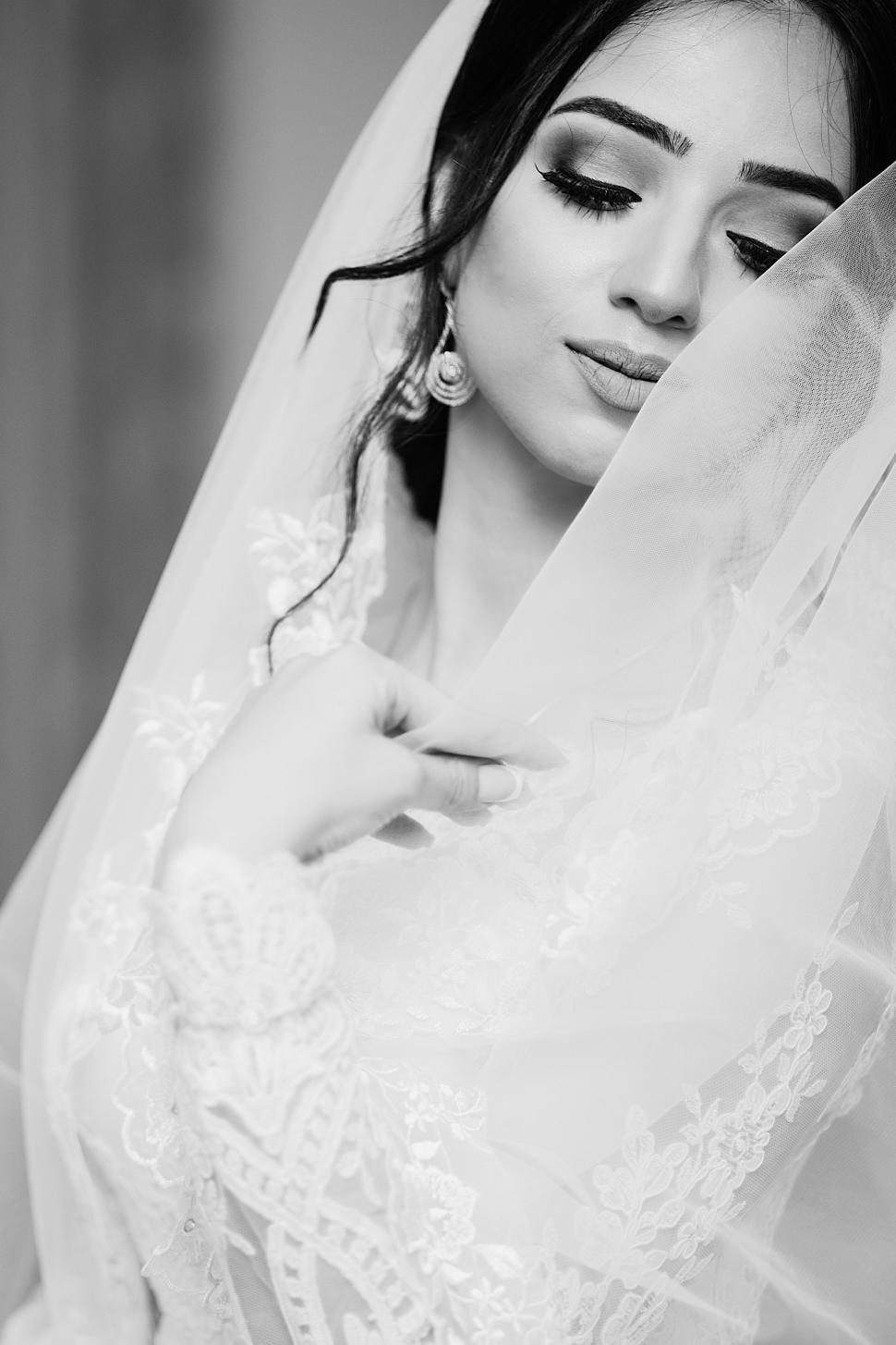Free Image of Woman in Wedding Dress and Veil Walking Down Aisle 