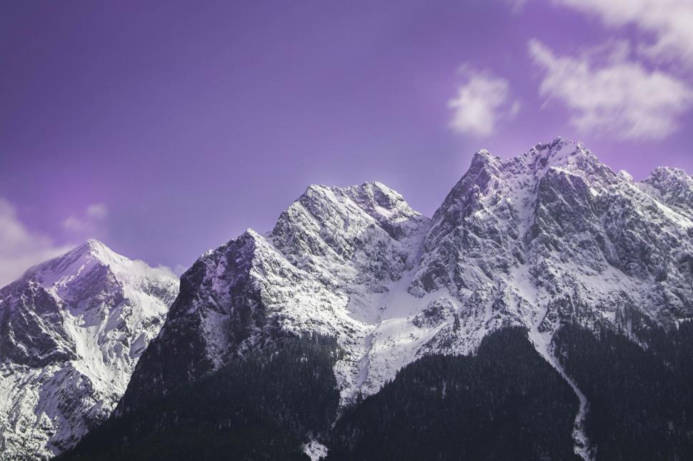 Free Image of Snow Covered Mountain Range Under a Purple Sky 