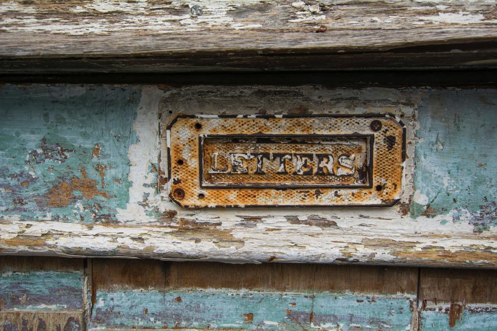 Free Image of Rusty Metal Plaque on Building Side 