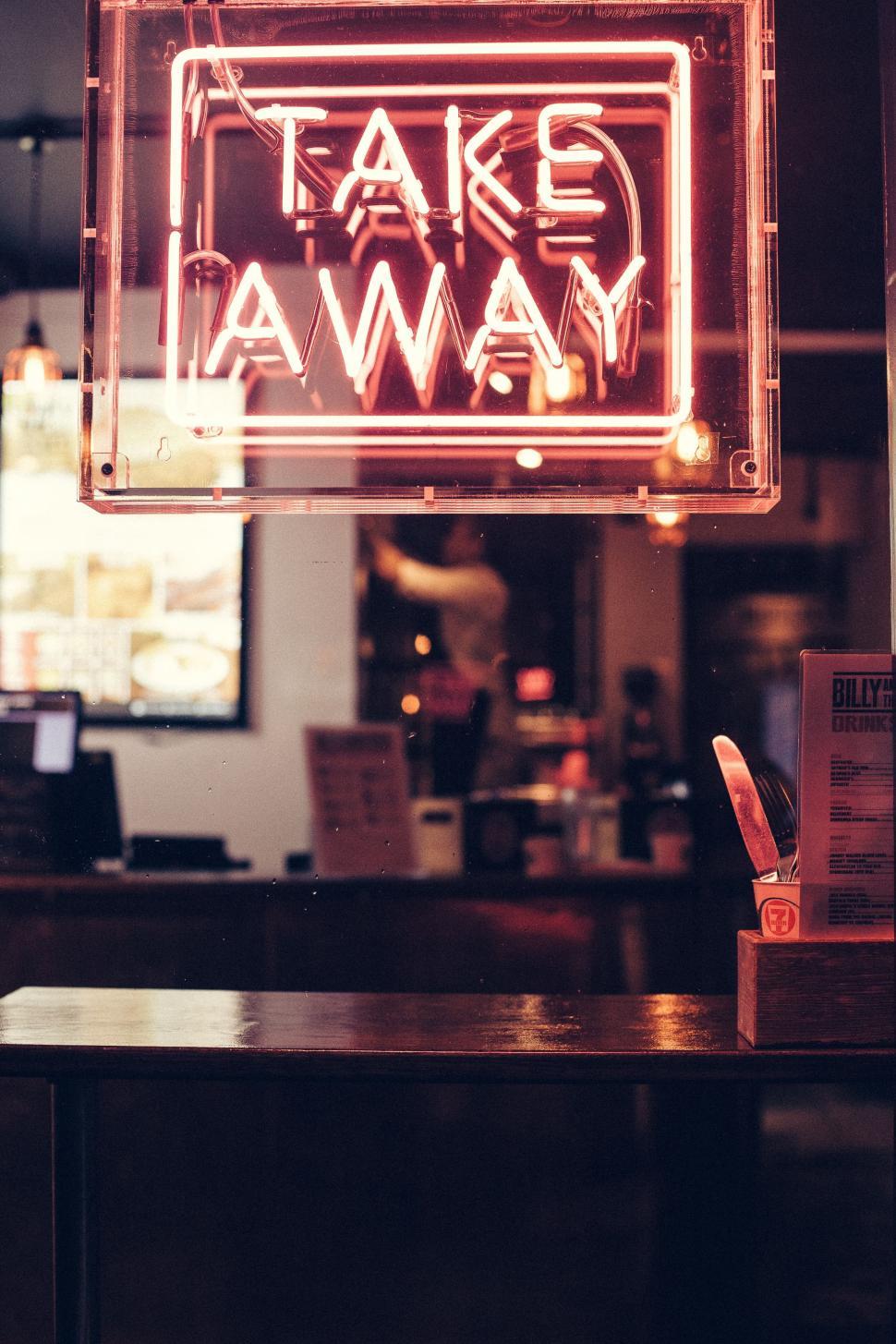 Free Image of Neon Sign Saying Take Away Hanging From Ceiling 