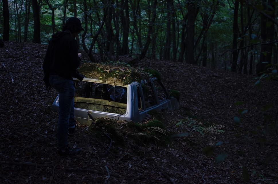 Free Image of Man Standing Beside Car in Forest 