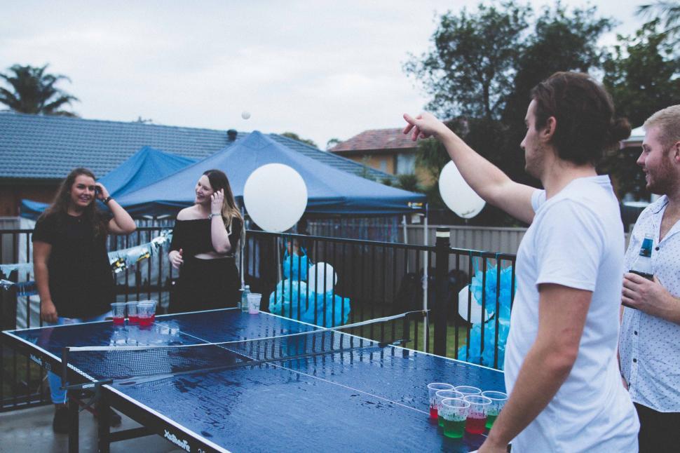 Free Image of Group of People Gathered Around a Ping Pong Table 