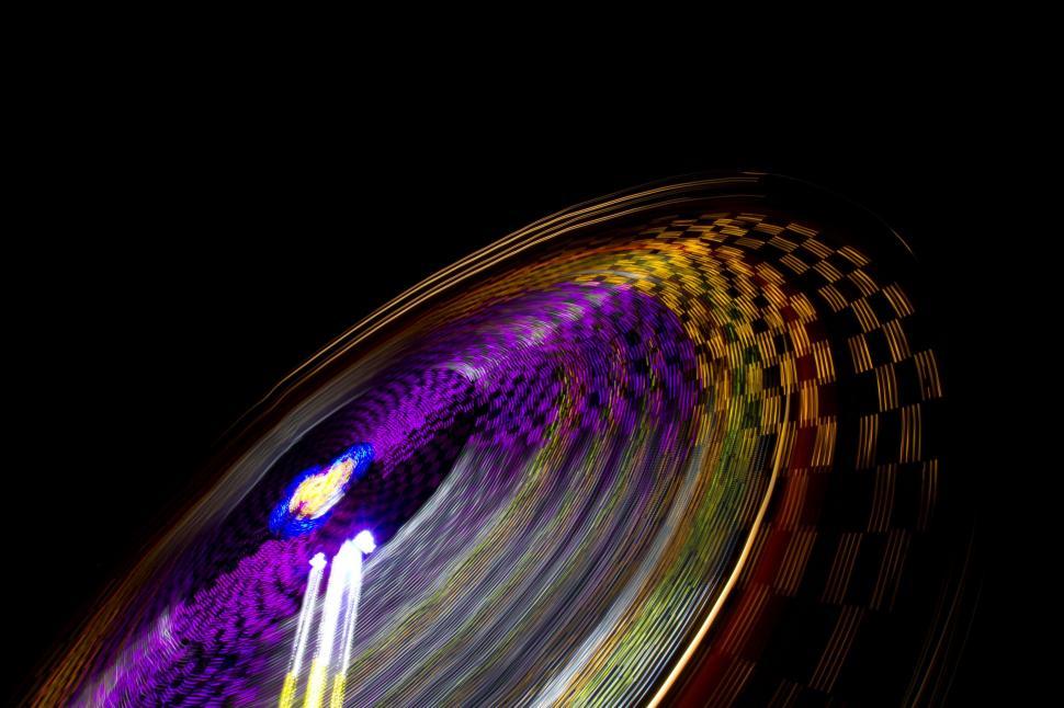 Free Image of Ferris Wheel Spinning in the Dark at Night 