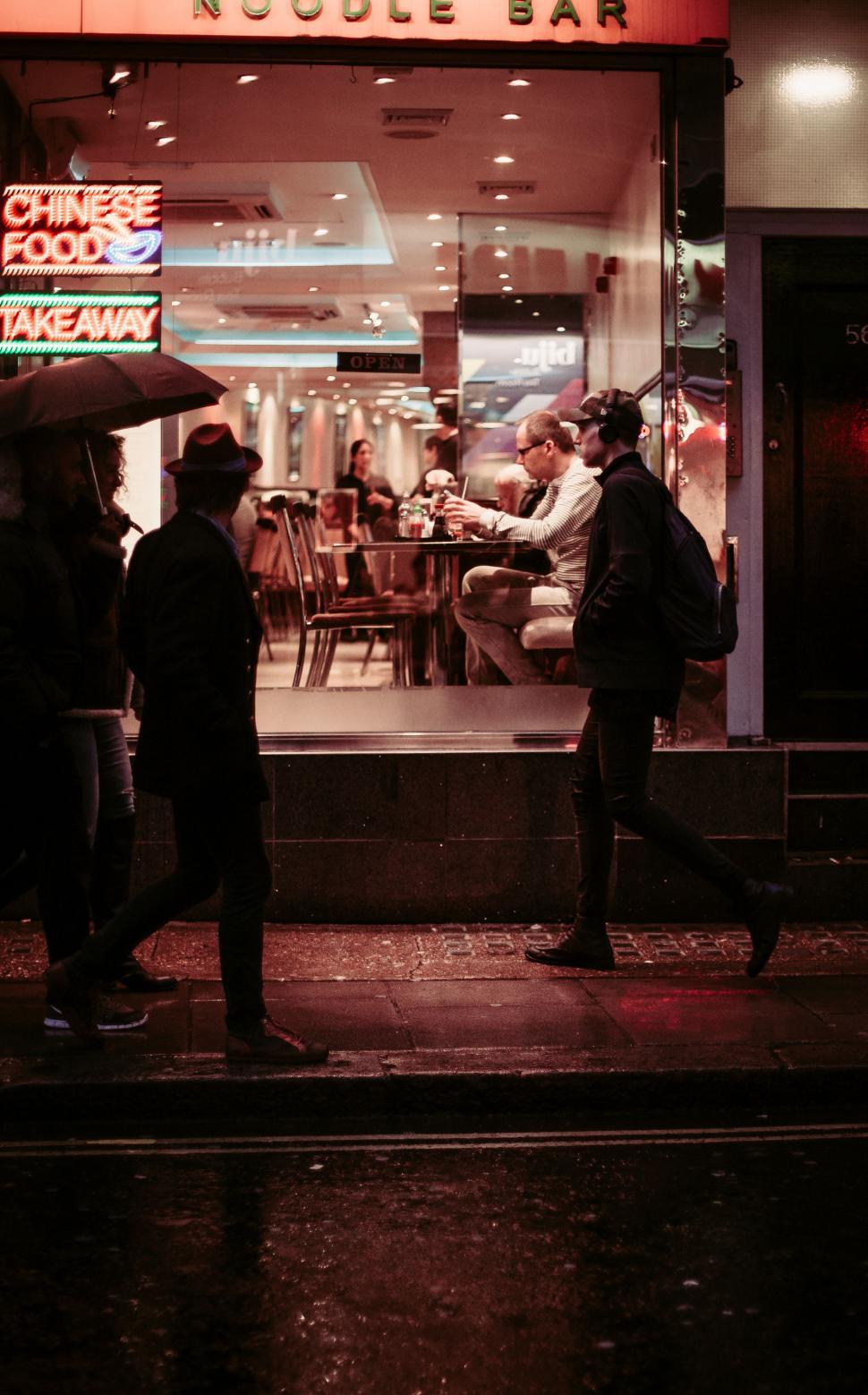 Free Image of Group of People Standing Outside of Restaurant 