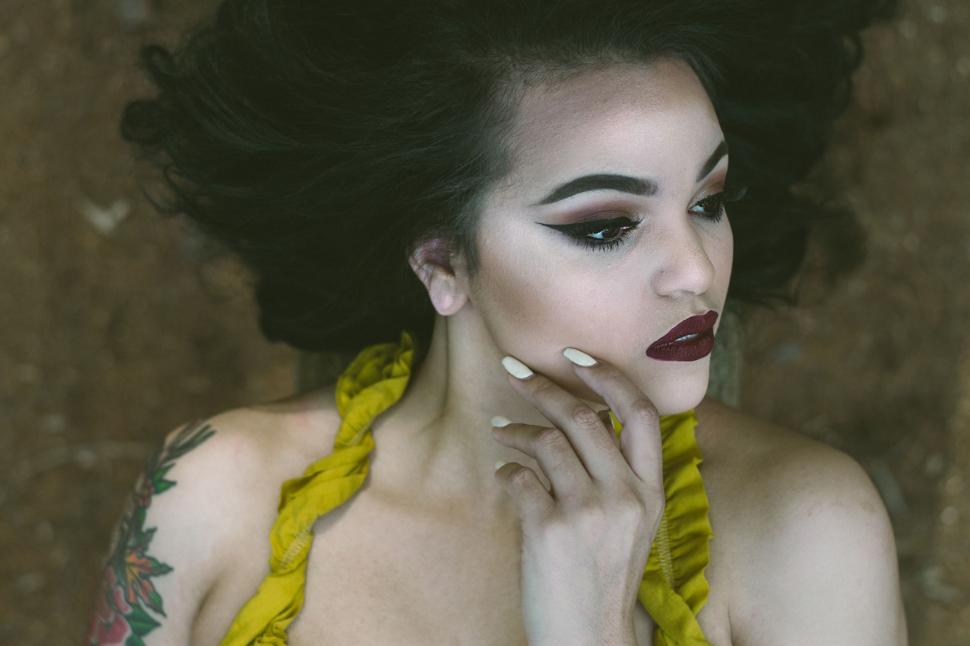 Free Image of Woman With Black and Yellow Makeup Posing 