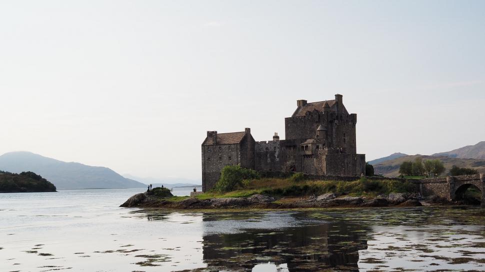 Free Image of Castle Overlooking Rocky Shore and Water 