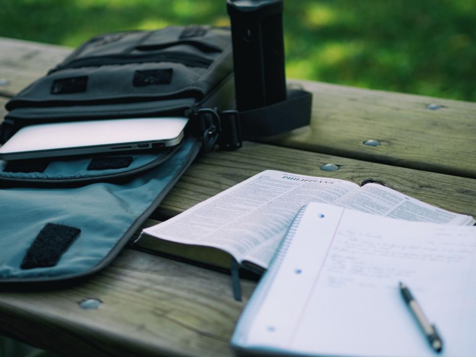 Free Image of Notebook, Pen, and Camera on Picnic Table 