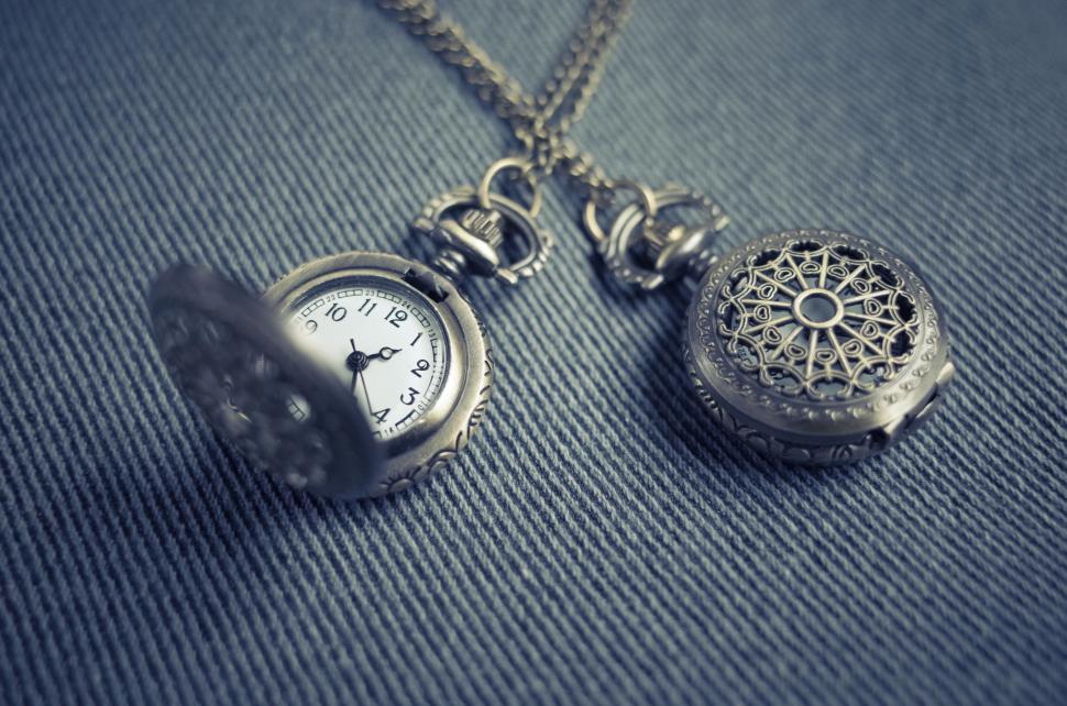 Free Image of Pocket Watch Sitting on Chain 