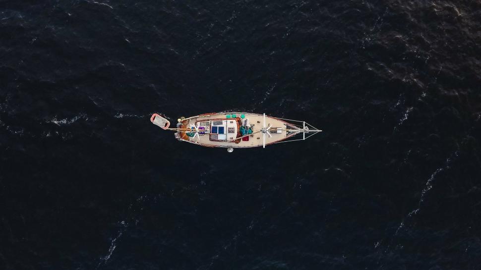 Free Image of Small Boat Adrift in Vast Ocean 