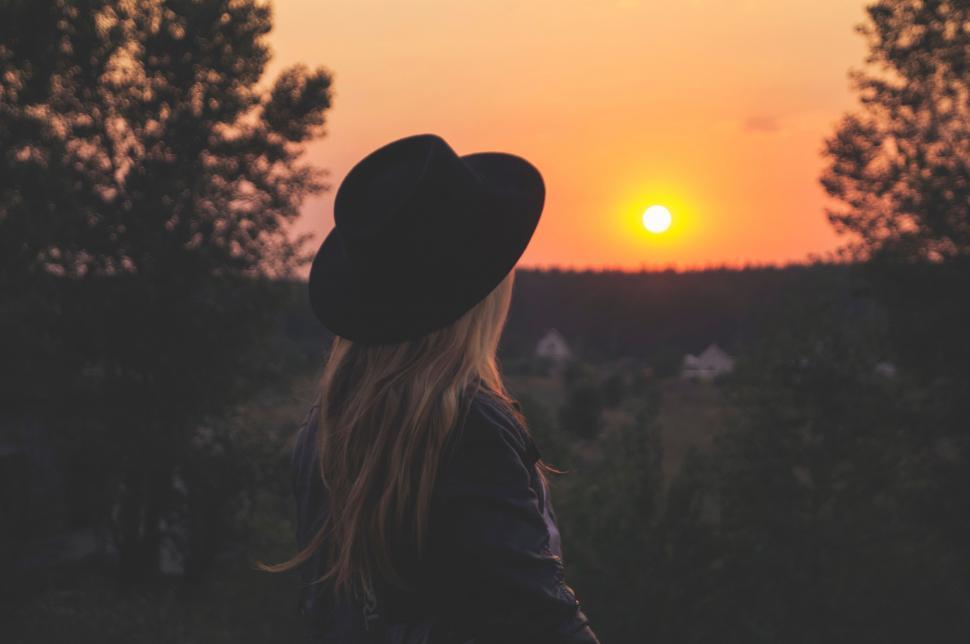 Free Image of Woman Standing in Field at Sunset 