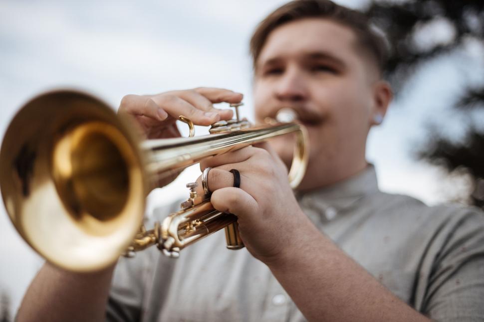 Free Image of Man Holding a Trumpet in His Right Hand 