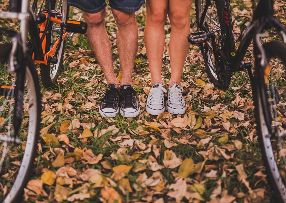 Free Image of Two People Standing With Bikes 