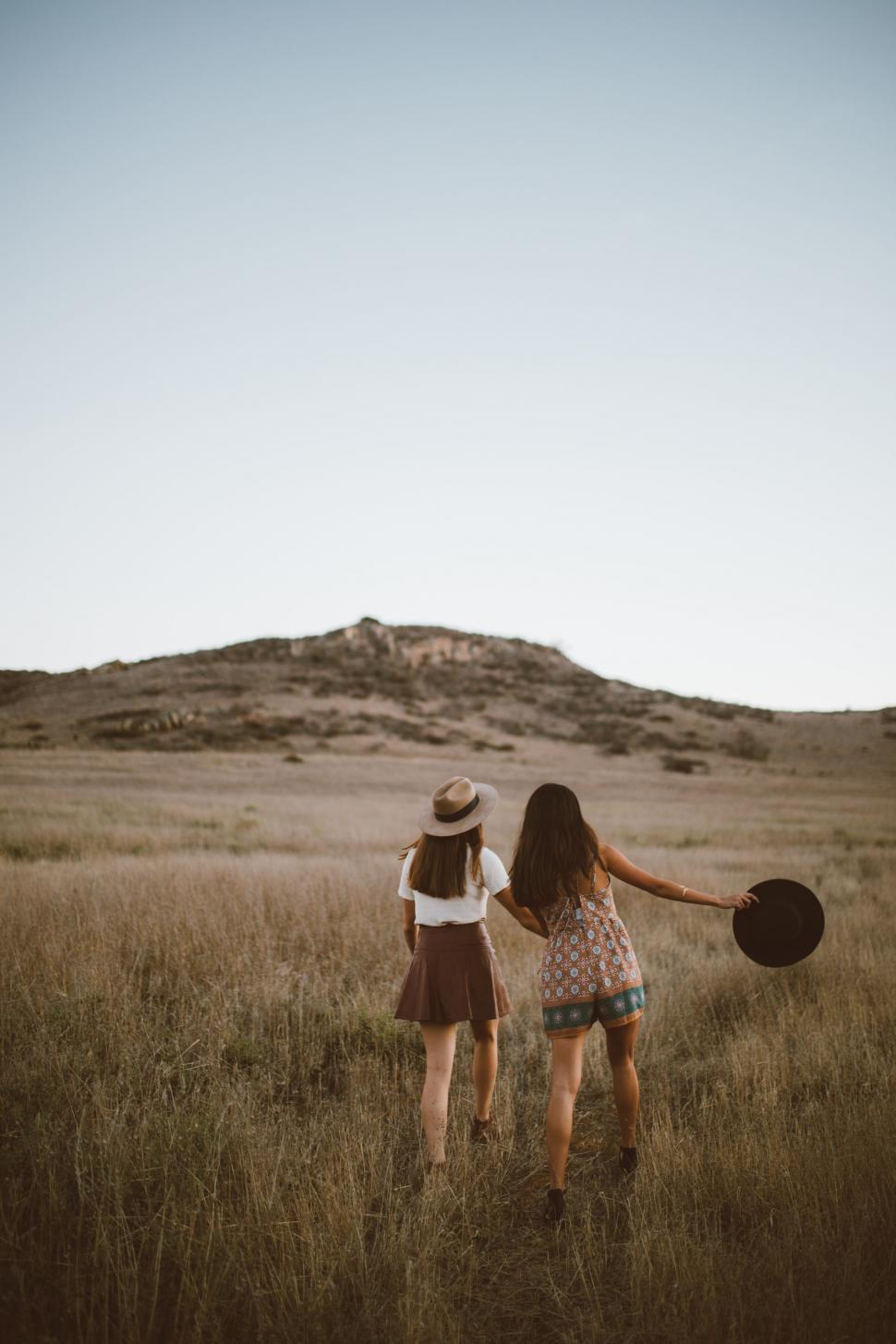 Free Image of Two Girls in a Field Holding a Frisbee 