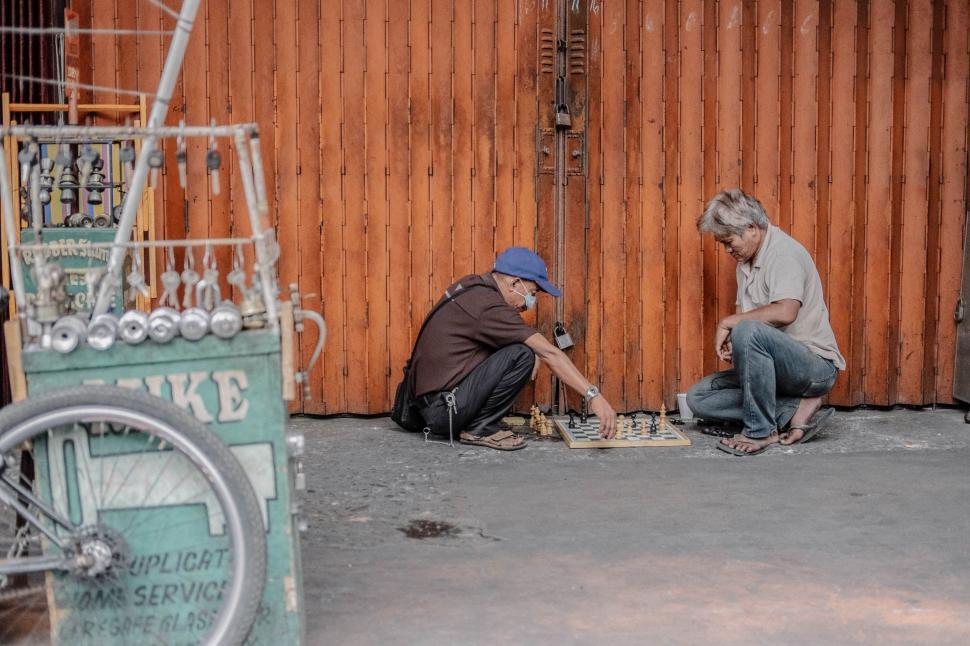 Free Image of Two Men Working on a Piece of Metal 