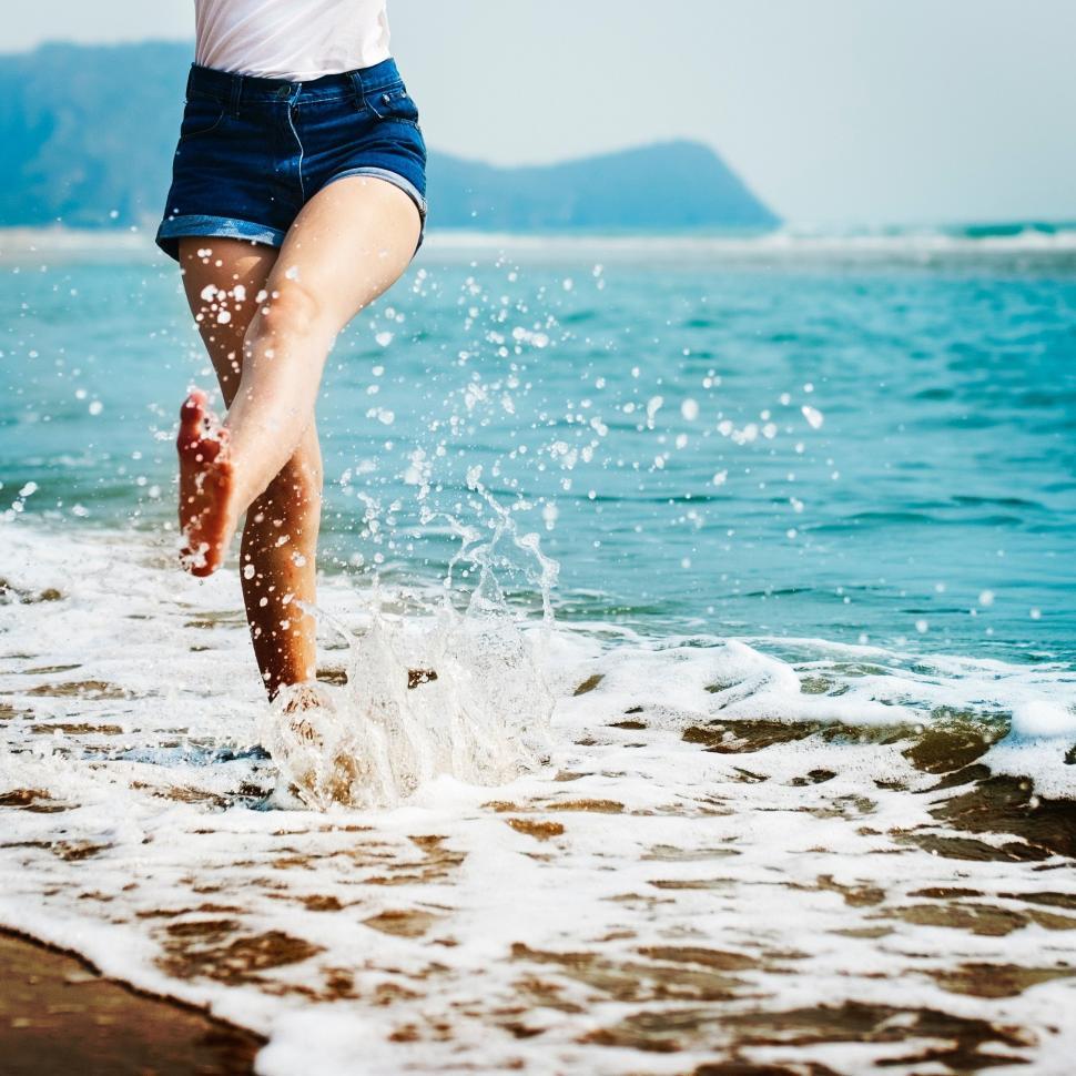 Free Image of Person Jumping Into the Water at the Beach 