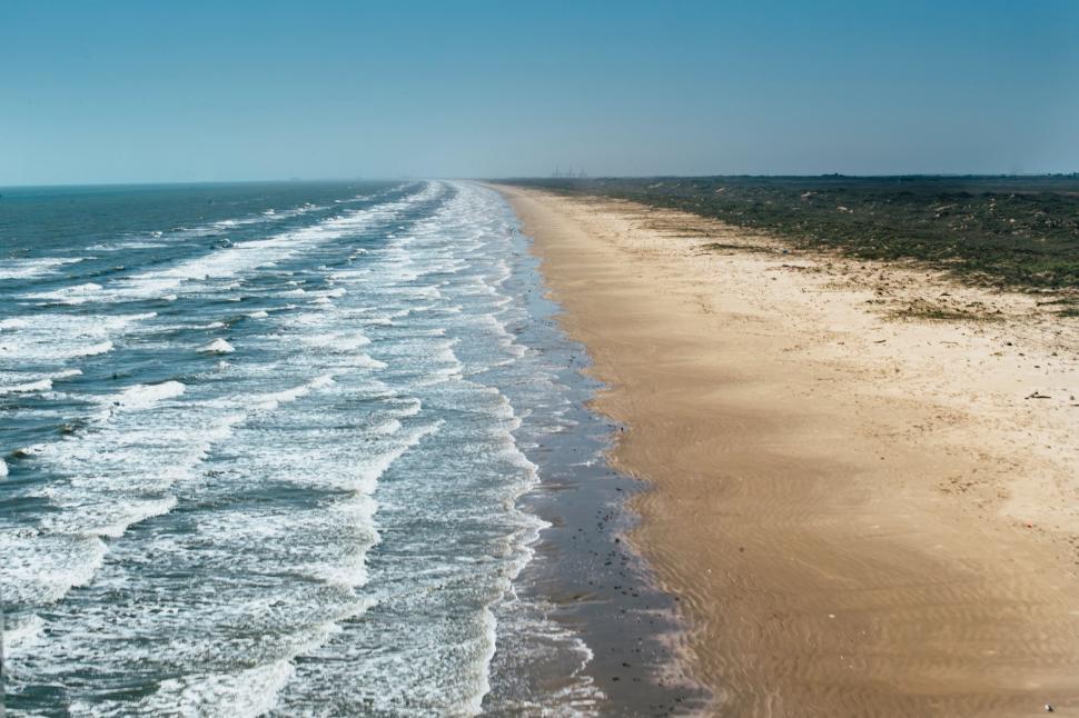Free Image of Sandy Beach Next to Ocean 