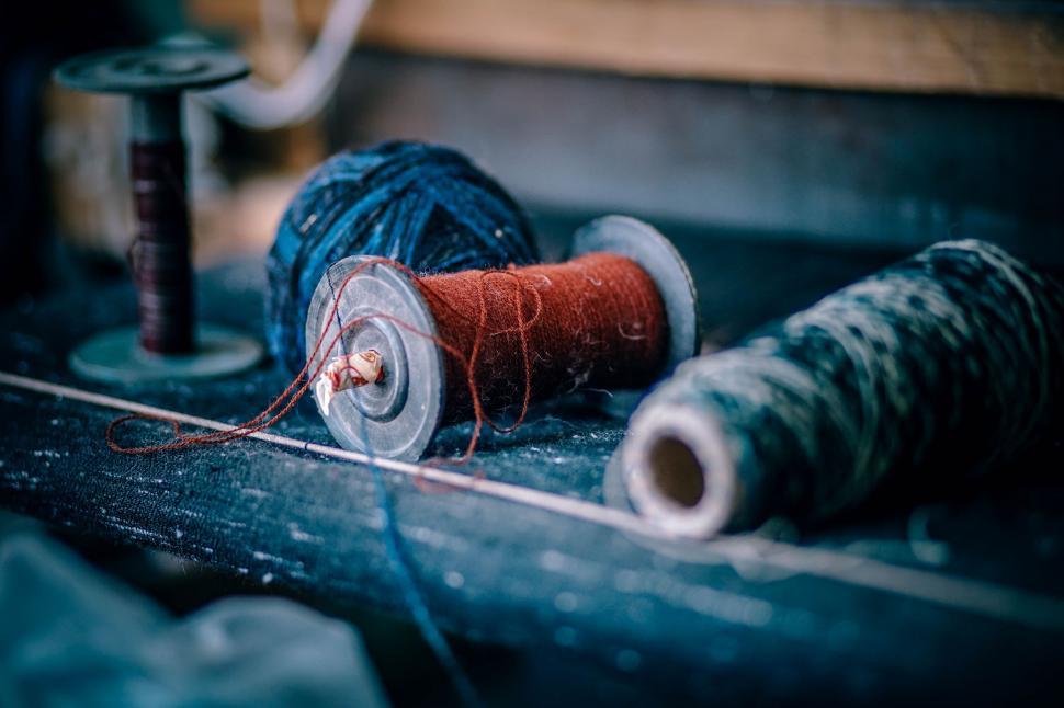 Free Image of Two Spools of Thread and a Spool of Thread on a Table 