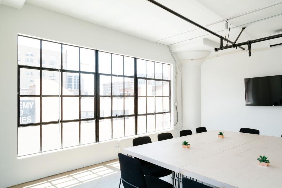 Free Image of Modern Conference Room With White Table and Black Chairs 